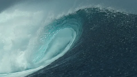 CLOSE UP: Crystal clear ocean water glistens in the sun while tube wave crashes. Stock Footage 92016546