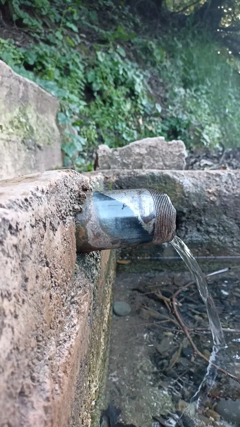 Close-up of Crystal Clear Spring Water Flowing in Nature Stock Footage 333531062