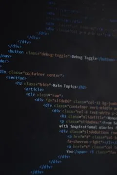 Close up css HTML code on monitor screen with black background Stock Photos