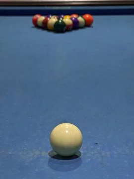 Close-up of cue ball on pool table with racked balls in background Stock Photos