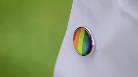 Close up of cufflink emblem with pride rainbow flag. LGBT wedding preparation Stock Footage 204123811