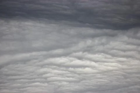 A close-up of cumulus clouds in the sky. The clouds are white and fluffy, a.. Stock Photos