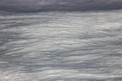 A close-up of cumulus clouds in the sky. The clouds are white and fluffy, a.. Stock Photos