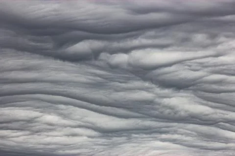 A close-up of cumulus clouds in the sky. The clouds are white and fluffy, a.. Stock Photos
