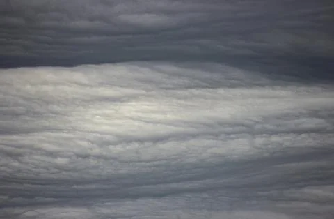 A close-up of cumulus clouds in the sky. The clouds are white and fluffy, a.. Stock Photos