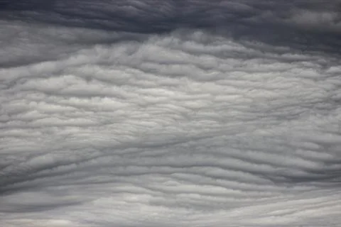A close-up of cumulus clouds in the sky. The clouds are white and fluffy, a.. Stock Photos
