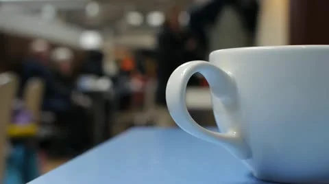 Close up of a cup in a busy cafe. Stock Footage
