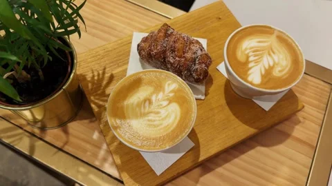 Close-up of a cup of coffee with dessert on the table restaurant. Stock Footage 275024981