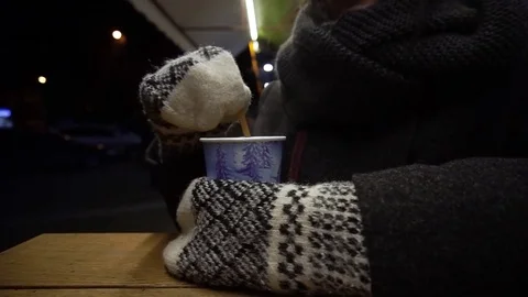 Close up of cup coffee or tea in the cold winter night. Girl with gloves. Slow Stock Footage 84606437