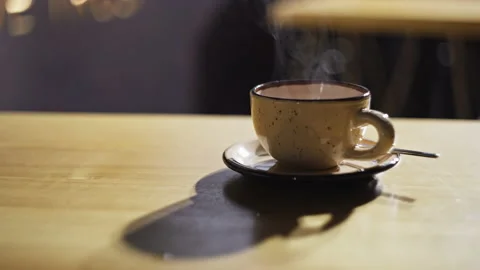 Close-up of a cup of coffee on a table in a cafe. Americano from which steams. Stock Footage 220922804