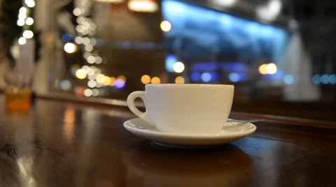 Close-up of a cup of coffee tea at the bar the night cars street Video stock 44469753