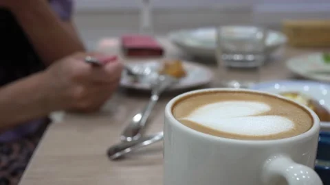 Close-up a cup of coffee on wooden table in restaurant. Stock Footage 159879282