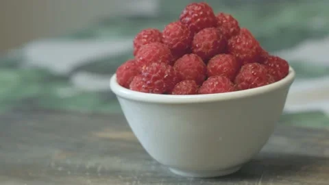 Close up of a cup of fresh raspberry on cutting board Stock Footage 134069395