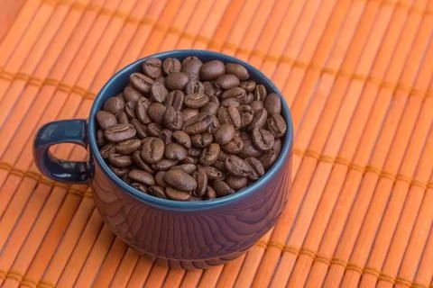 A close-up of a cup full of coffee beans Stock Photos