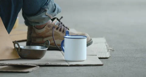 Close up on the cup of homeless man which people giving coin money Stock Footage 202782875