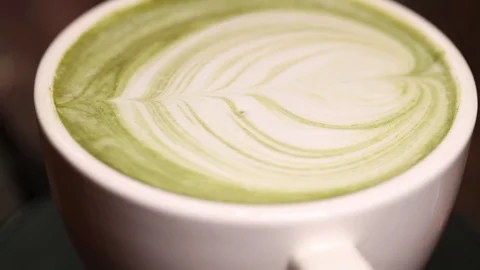 Close-up of cup of latte matcha coffee, spining loop Stock Footage 71026218