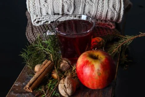 Close up of a cup with red tea on a decorated desk and sweaters Stock Photos