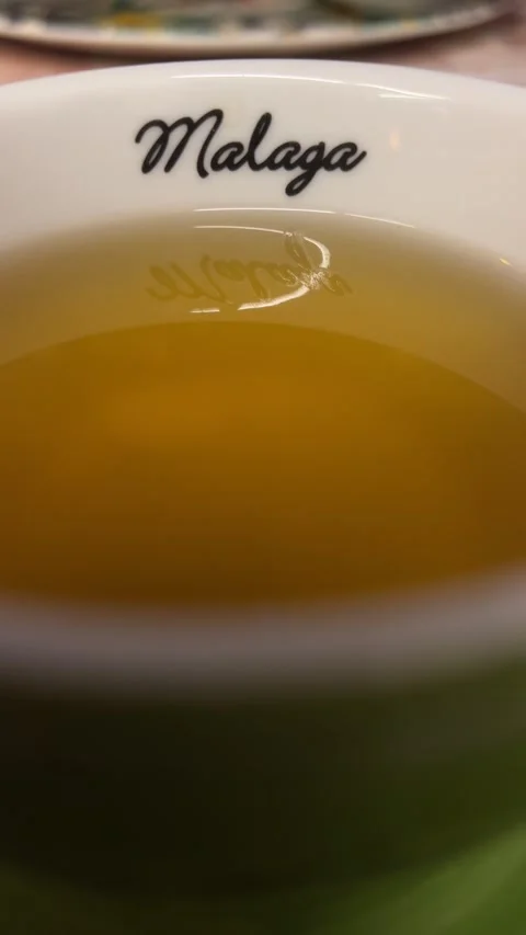 Close up of cup of tea with Malaga written on it. Vertical video Stock Footage 240921498