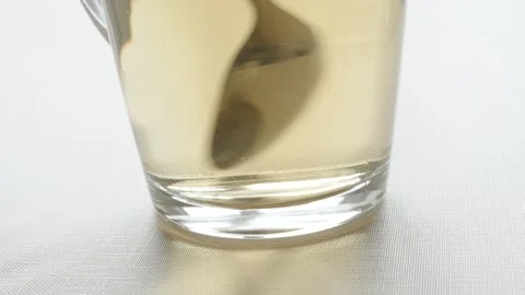Close-up of cup of tea slow motion video Stock Footage 97902216
