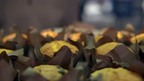 Close-up of cupcakes stand on a showcase in a store or cafe. A woman's hand Stock Footage 155378710