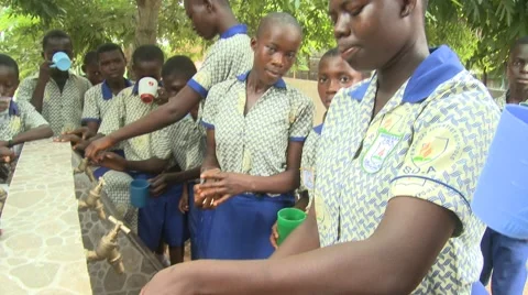 CLOSE UP: CUPS BEING FILLED WITH WATER PAN TO STUDENTS DRINKING Stock Footage 59865596