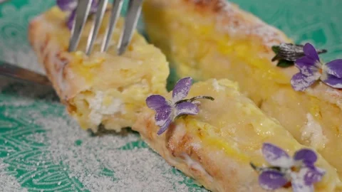 Close-up of a curd dessert on a plate being cut using a knife and fork Stock Footage 253550154