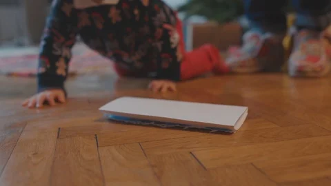 Close-up curious naughty cute boy baby in sweater crawling on the floor Stock Footage 124854738
