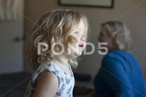 Close up of curious preschooler girl near grandmother Stock Photos