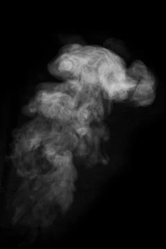 Close-up curls of steam or smoke with drops of moisture isolated on black bac Stock Photos