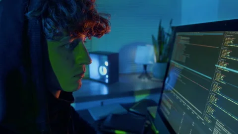 Close-up of Curly-Haired Guy Hacking Computer System in Dark Office Stock Footage 299264387