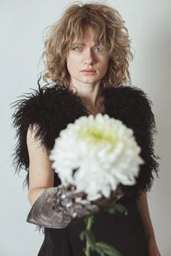 Close up curly haired model with dahlia in studio portrait picture Stock Photos