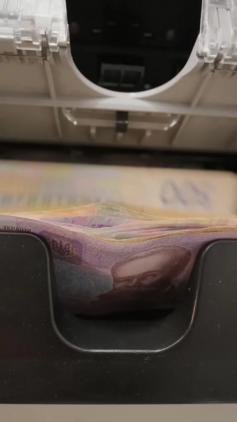 Close-up of currency counter machine processing Ukrainian Hryvnia. Banking conce Stock Footage 331504280