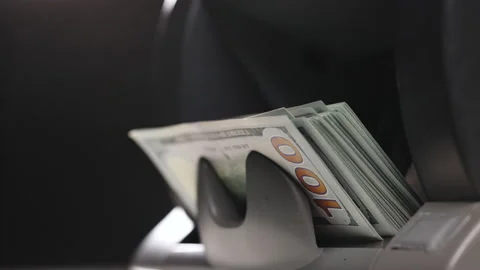 Close up of currency counting machine counting dollar banknotes. Male hand Stock Footage 231049662
