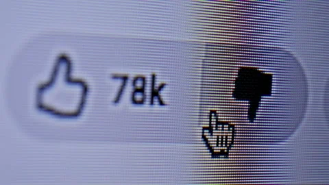 Close-up of a cursor clicking the Dislike button on a social media interface. Stock Footage 336681299