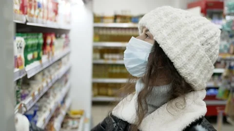 Close-up of customer during quarantine in winter choosing food in store Stock Footage 145223843