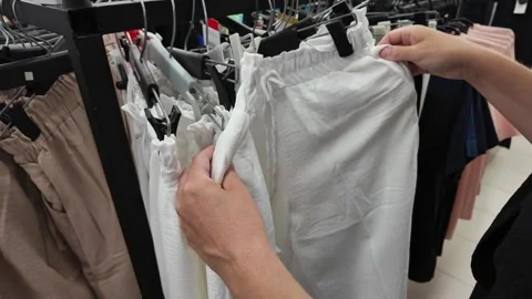 Close Up Customer Hand Browsing Trousers Rack Stock Footage 265066309