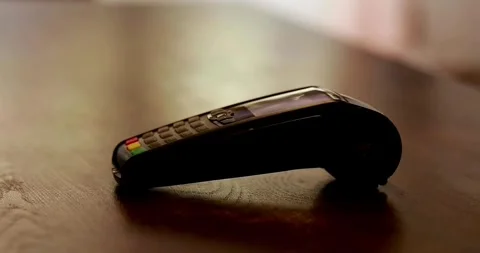 Close-up customer hand uses smartphone to make a wireless payment nfc technology Vídeos de archivo 336585667