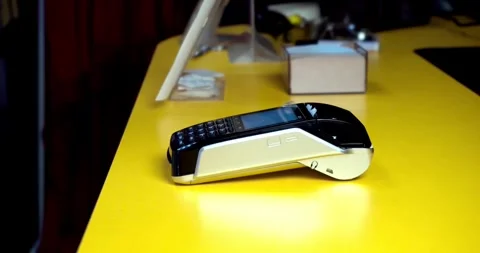 Close-up customer hand uses smartphone to make a wireless payment nfc technology Video stock 336585671