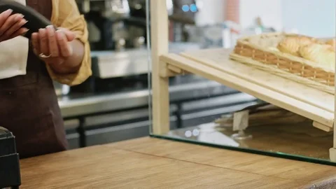 Close up of a customer making contactless smartphone payment Stock Footage 77178012