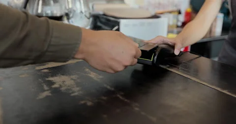 Close up customer pay for takeaway coffee using credit card contactless payment Stock Footage 159562523