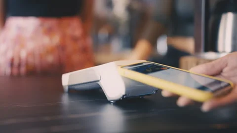 Close-up of customer paying for service using smartphone, cashless payment Stock Footage 221706234