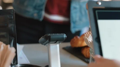 Close up customer paying using credit card contactless payment spending money in Stock Footage 103472414