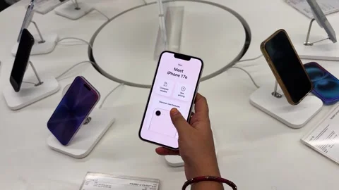 Close up of customer using apple smartphone at technology store with product Stock Footage 340958047