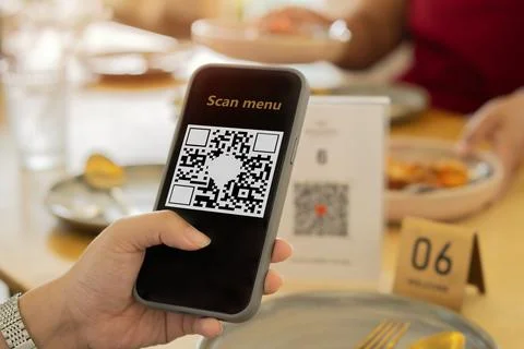 Close-up on customers checking the menu by QR code at a restaurant Stock-Fotos