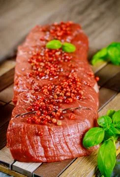 Close up cut bottom round beef with spices. Stock Photos