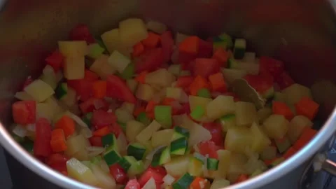 Close-up of cut, brightly colored vegetables in a pot Stock Footage 265783911
