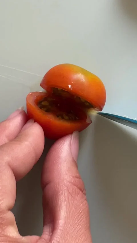 Close up cut a cherry tomato. Stock Footage 287860531