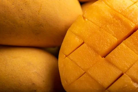 Close up of cut mango pieces against a dark background Stock Photos