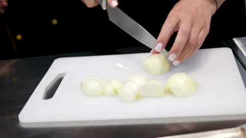 Close-up. cut onions Chef chopping an onion with fine pressure on a cutting Stock Footage 279897839