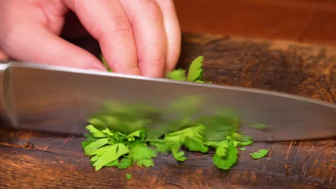 Close-up of cut parsley on a board in the kitchen with a knife. Stock Footage 248153590